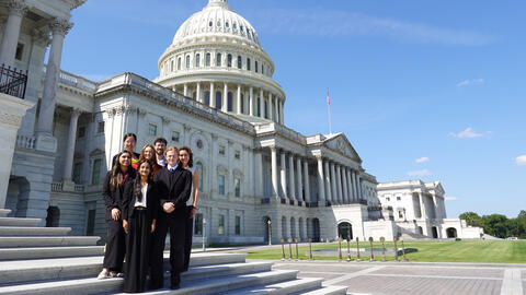 Several students pose on the steps of the U.S. Capitol following the final site visit of Honors College.