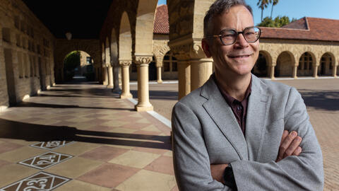 Colin H. Kahl under the arches of Stanford's main quad