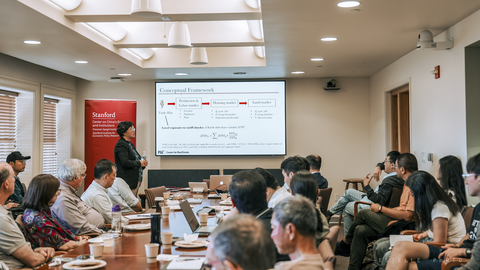 A full room during a seminar presentation. 