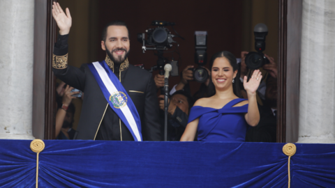 Nayib Bukele and Gabriela Roberta Rodríguez de Bukele, president and first lady of El Salvador, wave to supporters from a balcony.