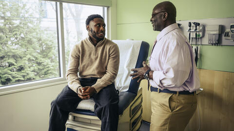 Older physician and young patient