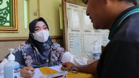 A doctor meets with a patient at the Banyumas Hospital in Indonesia.