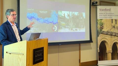Gavin Shatkin delivers a presentation from a lectern.