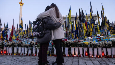 People arrive to pay tribute at Maidan Square, where thousands of memorial flags are on display as a reminder of the toll of the war on February 24, 2025, in Kyiv, Ukraine.