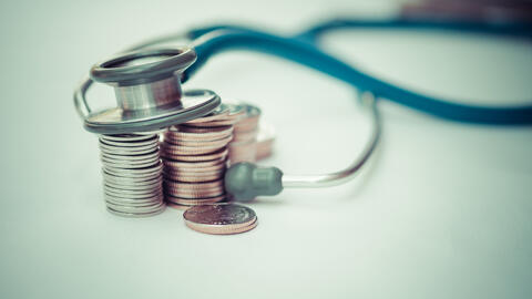 Stethoscope and coins