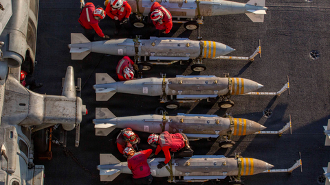 U.S. Navy members prepare to stage ordnance on the flight deck of Nimitz-class aircraft carrier USS Abraham Lincoln in support of Operation Epic Fury. 