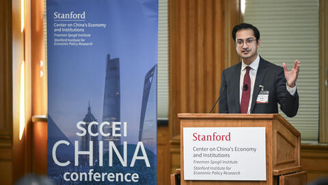Rush Doshi speaks behind a podium at the SCCEI China Conference