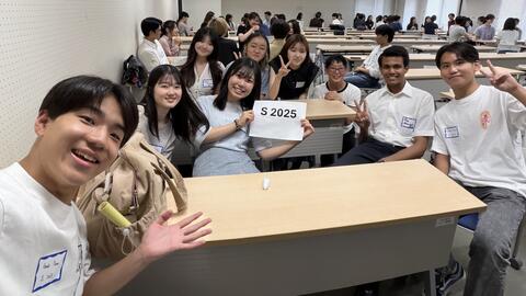 students gathered around a desk