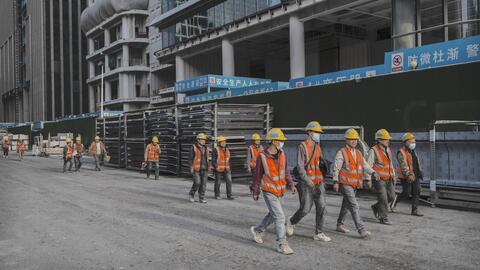 Construction workers leave a work site in the Central Business District on April 10, 2025 in Beijing, China. 