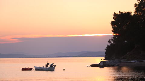 sunset photo of a small boat