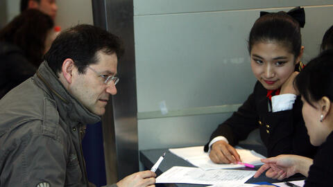 A foreign job seeker talks with two Chinese employers during a job fair for foreigners at the Beijing Talent Tower in March 2008 in Beijing, China.