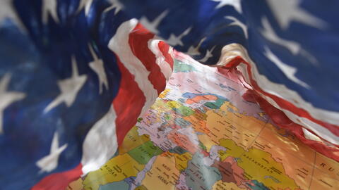 U.S. flag on top of a world map