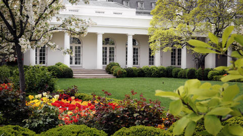 The  West Wing of the White House, partially obscured by trees