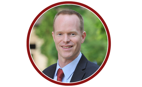 Grant Miller headshot in a circular frame.