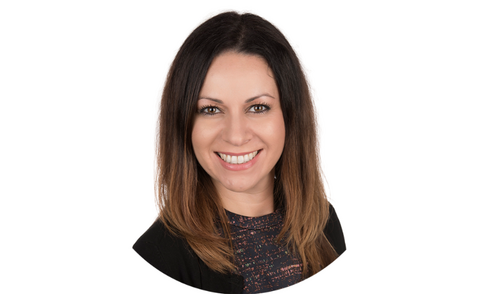 Smiling woman with shoulder length brown hair. 