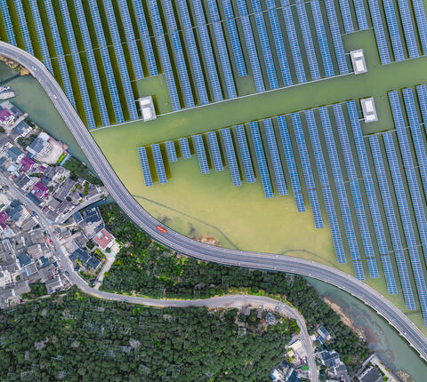 Solar power station above a lake and next to a residential town in Suzhou, China.