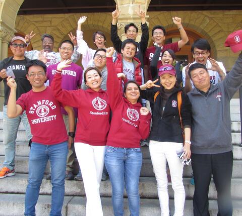2015-16 Global Affiliate visiting fellows posing for the camera at the entrance to Encina Hall, Stanford.