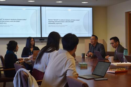 Participants at a Stanford Next Asia Policy Lab seminar sitting around a table in a conference room.