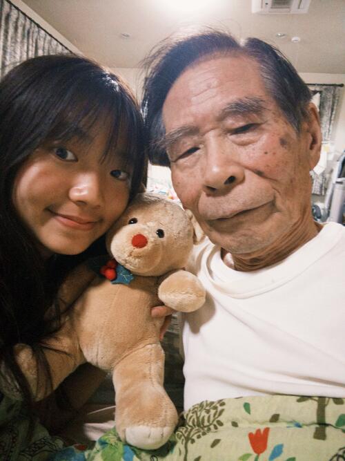 two people and a stuffed animal in the middle