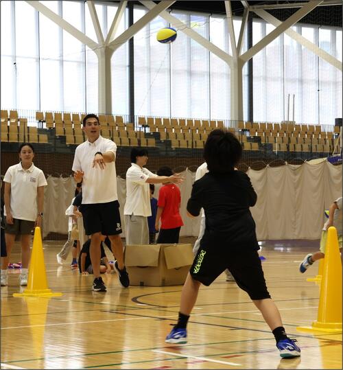 a person giving an instruction in a gym