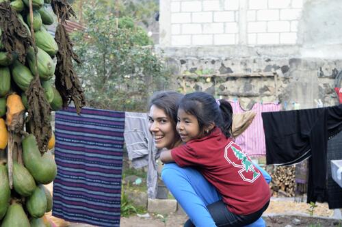 Fátima shows off her Stanford gear as she gets a ride from medical student Victoria Bawel. Because of contributions from FSI, children like Fátima are getting the nutritional supplements they need. 26904174966 b790e2fc26 o