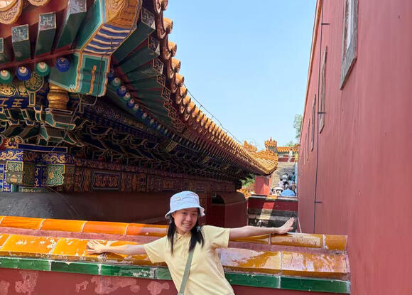 a student standing in front of a building