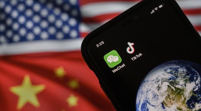 Photo of a cell phone with the US and Chinese flags in the backdrop