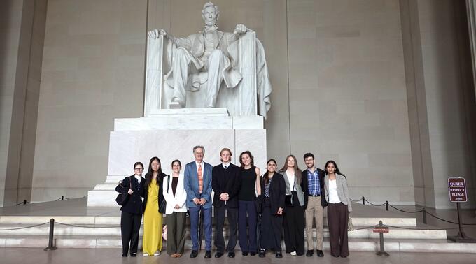 Students and faculty pose in front of the Lincoln Memorial during Honors College in Washington, D.C.