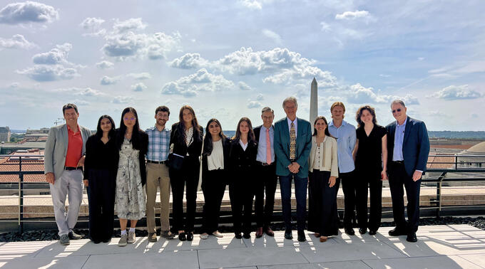 Kevin Sheives (L), director of the International Forum for Democratic Studies, and Damon Wilson (center), CEO of the National Endowment for Democracy, pose with students and faculty.