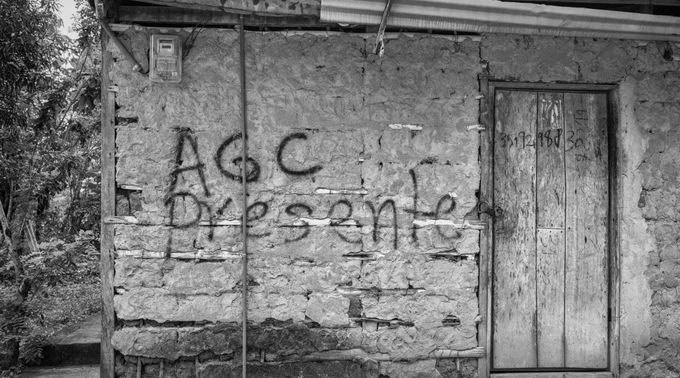 Graffiti on the wall of a home in Montes de María reads “AGC: Presente,” which translates as “AGC is present.”