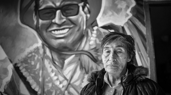 Leopolda Guevara Ismodes stands before a mural honoring her son, Jlinner Remo Candia Guevara, who was killed on January 11, 2023, in Cusco.
