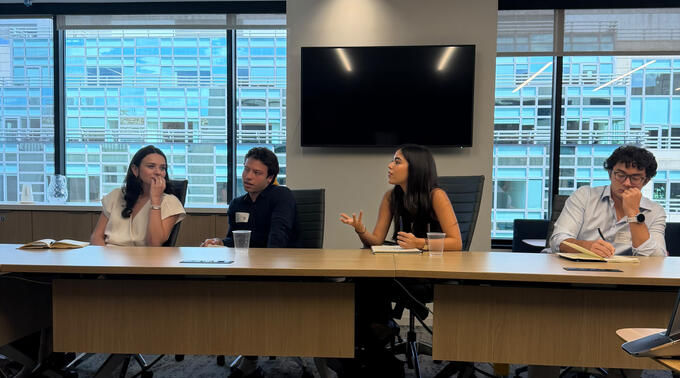 Amalia (center right) engages with a speaker during a site visit.