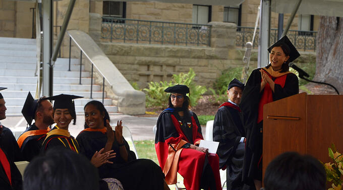 Soomin Jun, the student speaker at MIP graduation, laughs with classmates