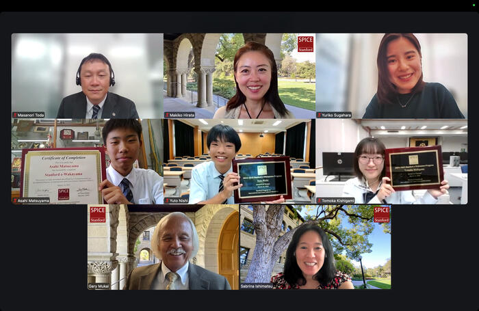 zoom screenshot of students holding plaques