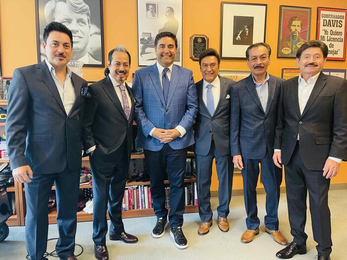 men in suits standing in a room