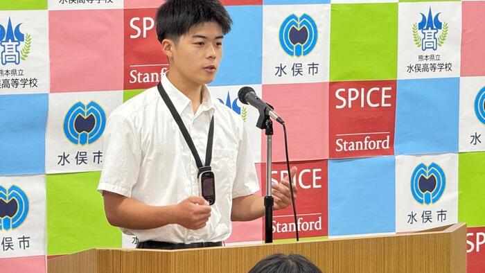 a student in uniform giving a speech at the podium