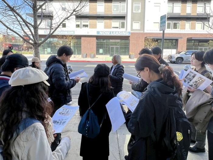 students reading documents during a tour
