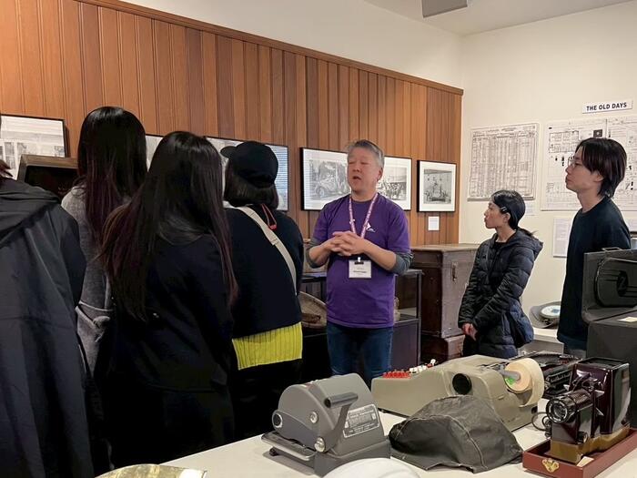 students gathered around a person in a purple shirt