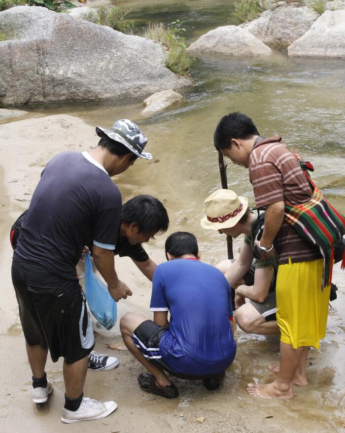 A researcher engaging with fishermen while conducting an ethnographic study.