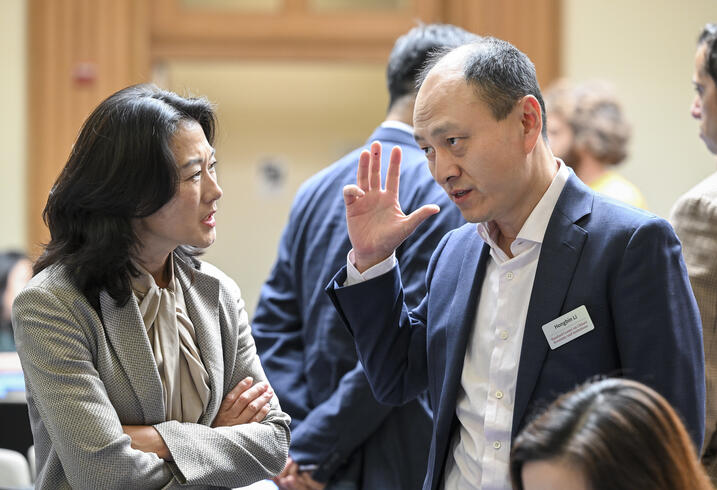 Hongbin Li speaks with an audience member at the China Conference.