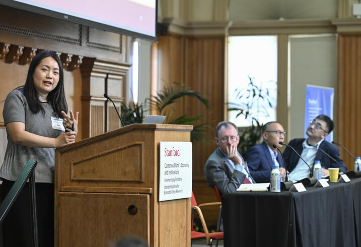 Jia Nan speaks at the podium during a panel session at the SCCEI China Conference.