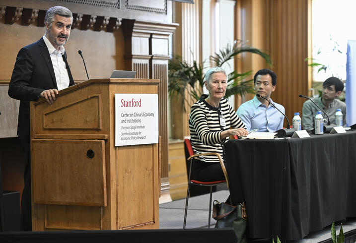 Ramin Toloui speaks at a podium.