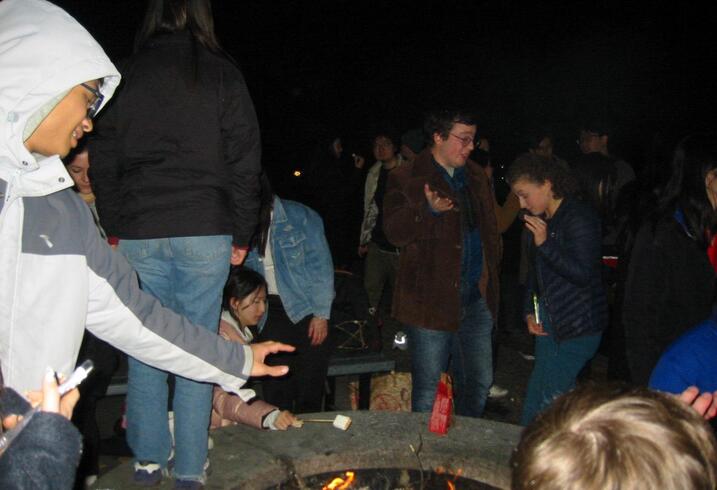 Students from the Forum for American-Chinese Exchange at Stanford at an evening bonfire.