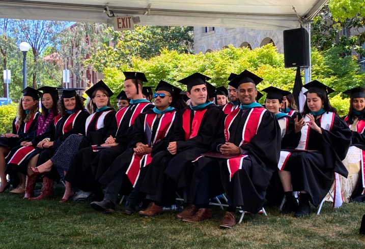 The Class of 2025 of the Ford Dorsey Master's in International Policy sitting together at their graduation ceremony on the lawn of Encina Hall at Stanford University. 