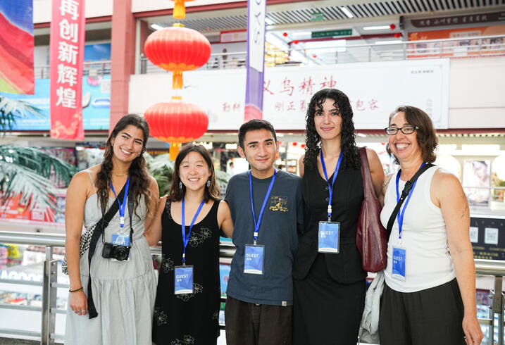 A group smiles in a Chinese market.