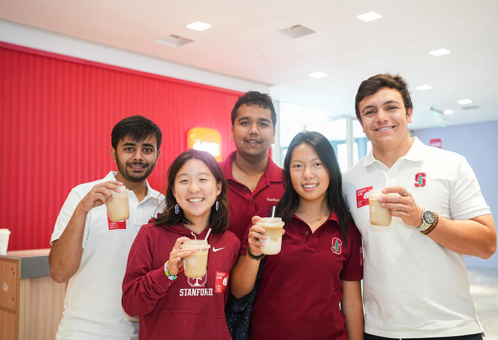 Students pose with coffee drinks.