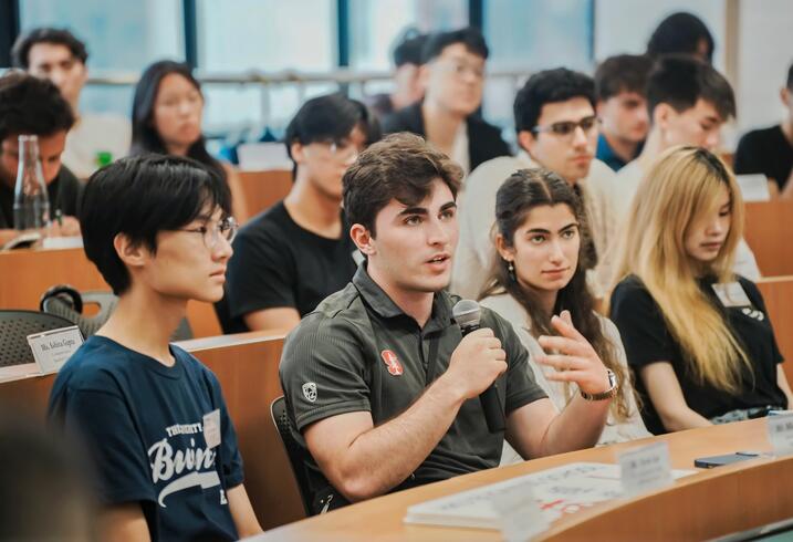 Student discusses while seated in a classroom.