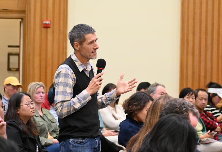 Carsten Holz asks a question from the audience of an event.