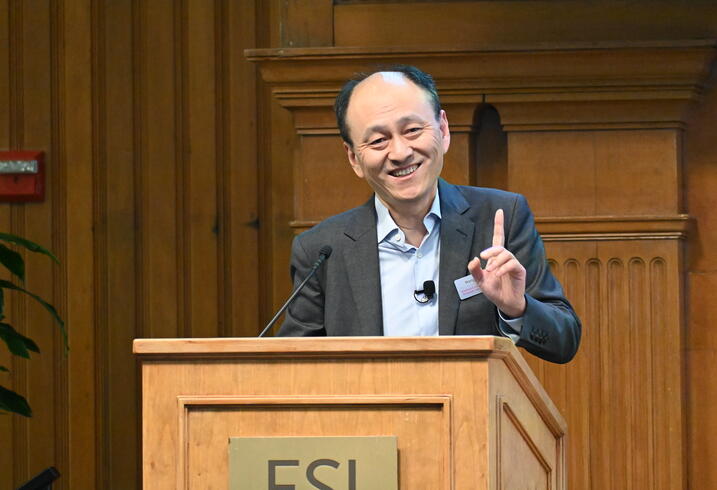 Hongbin Li speaks at the podium.