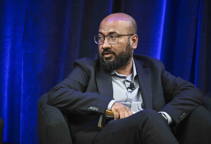 Tasneem Khalil seated on a stage during a panel discussion.